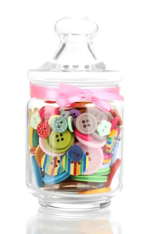 Use empty glass candle jars to store craft supplies.